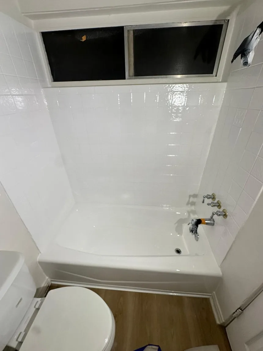 The same wall refinished in one even white, the decorative band coated over.