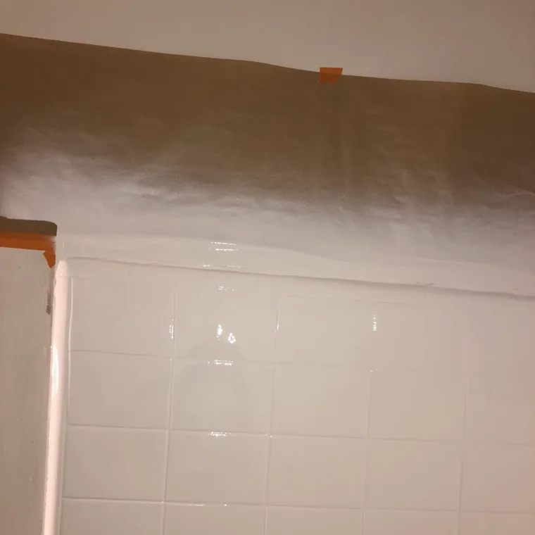 The finished wall masked off above and coated, with a glossy even surface.